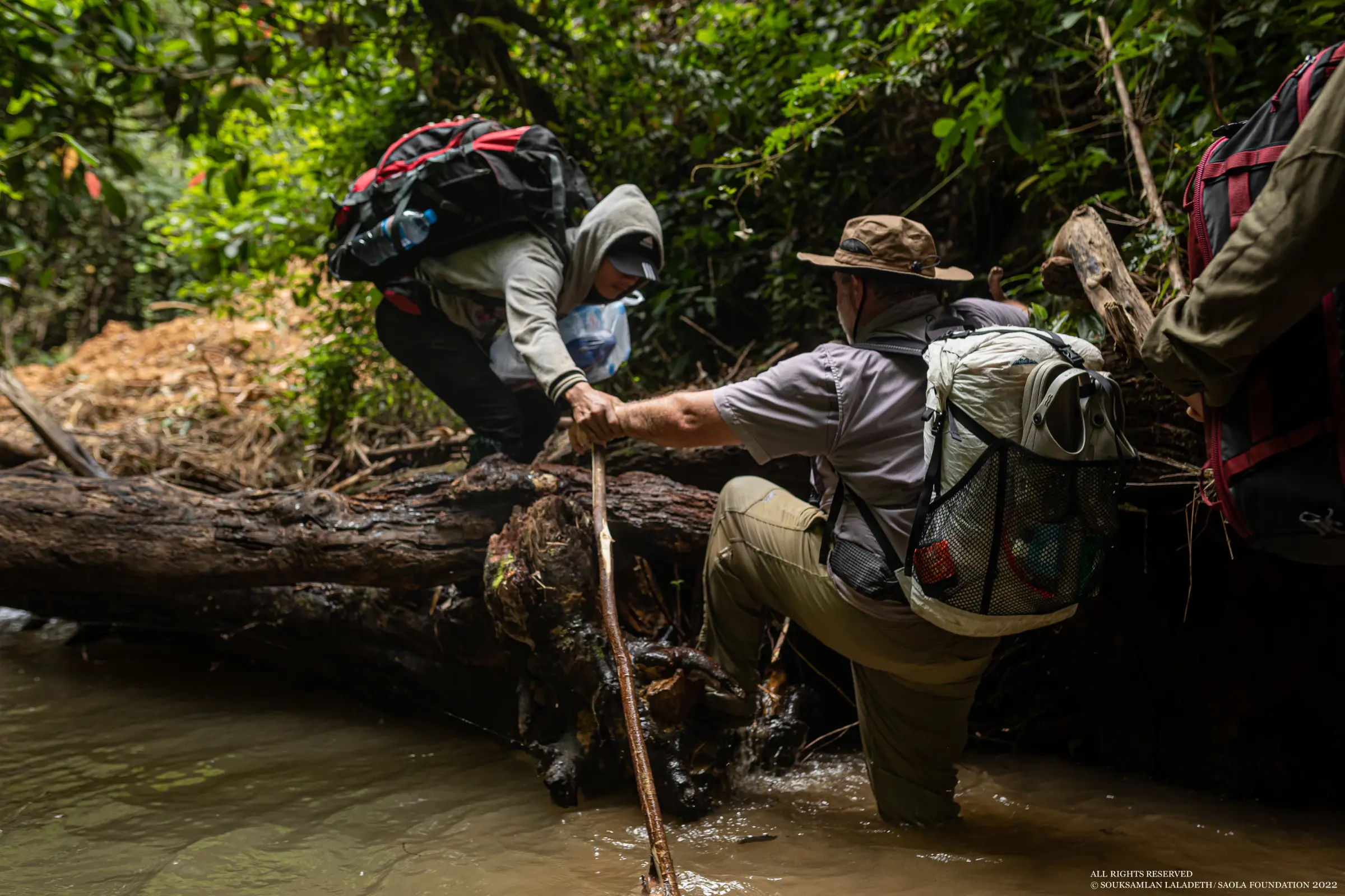 Paul and Aimee traveling through the Annamites with the Saola Foundation team along rivers and difficult terrain. Photos: Souksamlan Laladeth / Saola Foundation