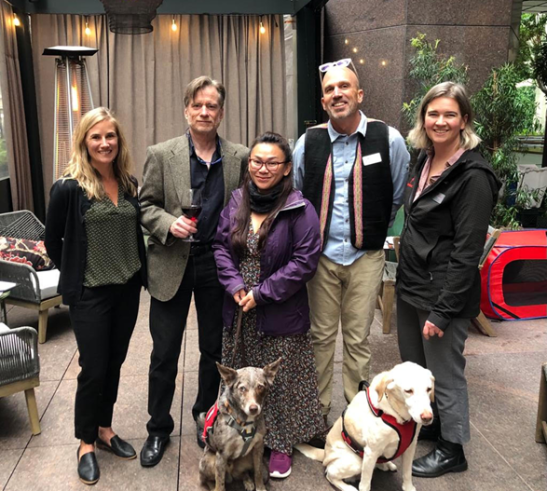 Vatsana, in the purple coat, along with one of the dogs she trains with.